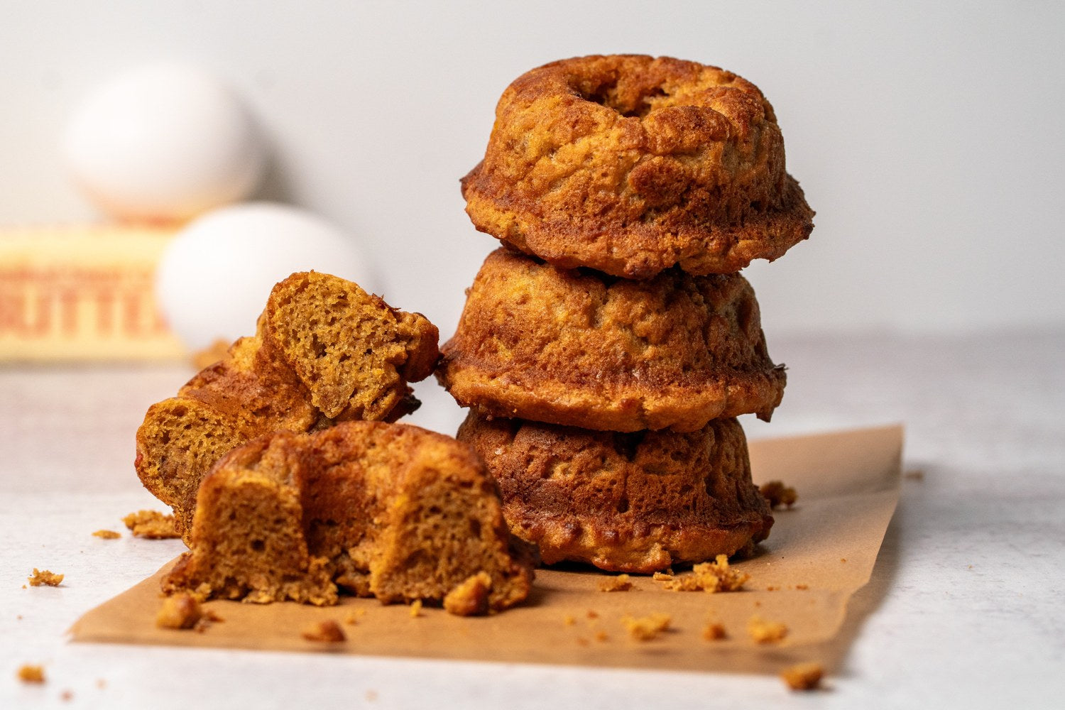 A stack of golden sweet potato donuts with a soft, tender crumb